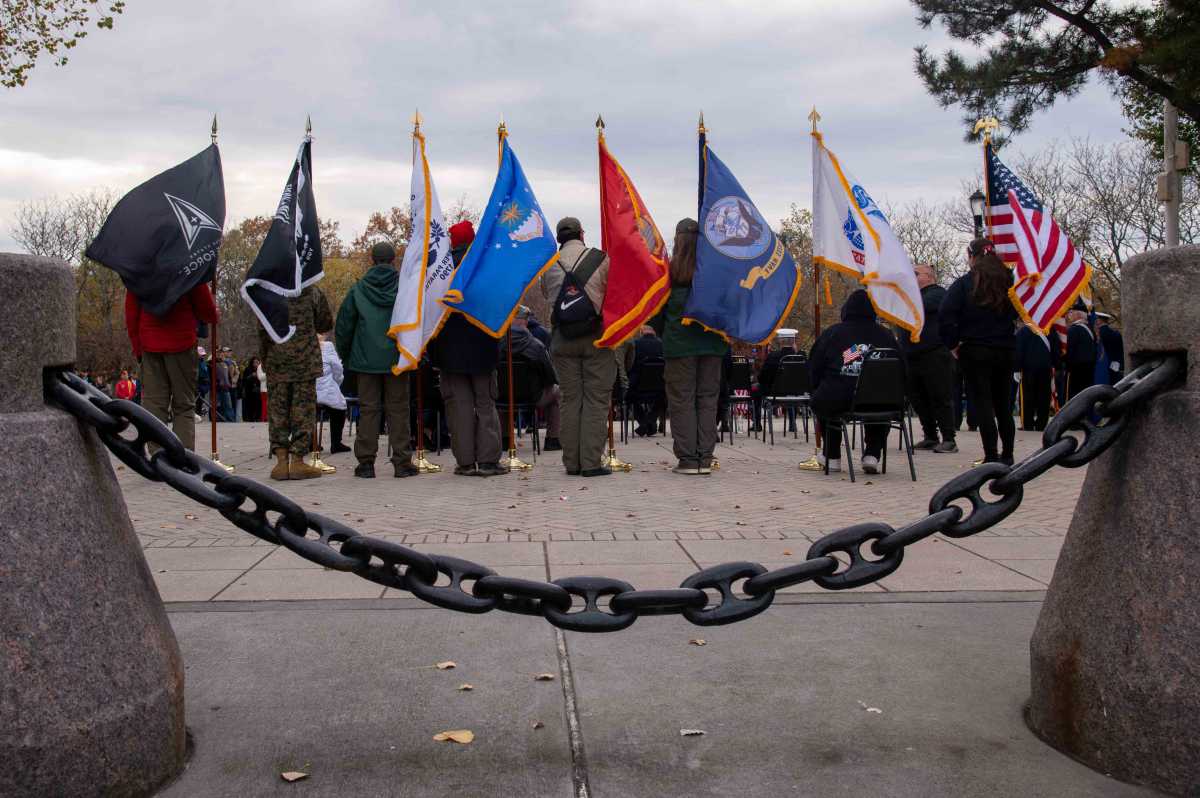 A color guard stands behind the stage at the ceremony following the Veterans Day Parade in Throggs Neck.