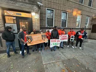 Tenants stand outside their building on Findley Avenue to protest its landlord, David Tennenbaum.
