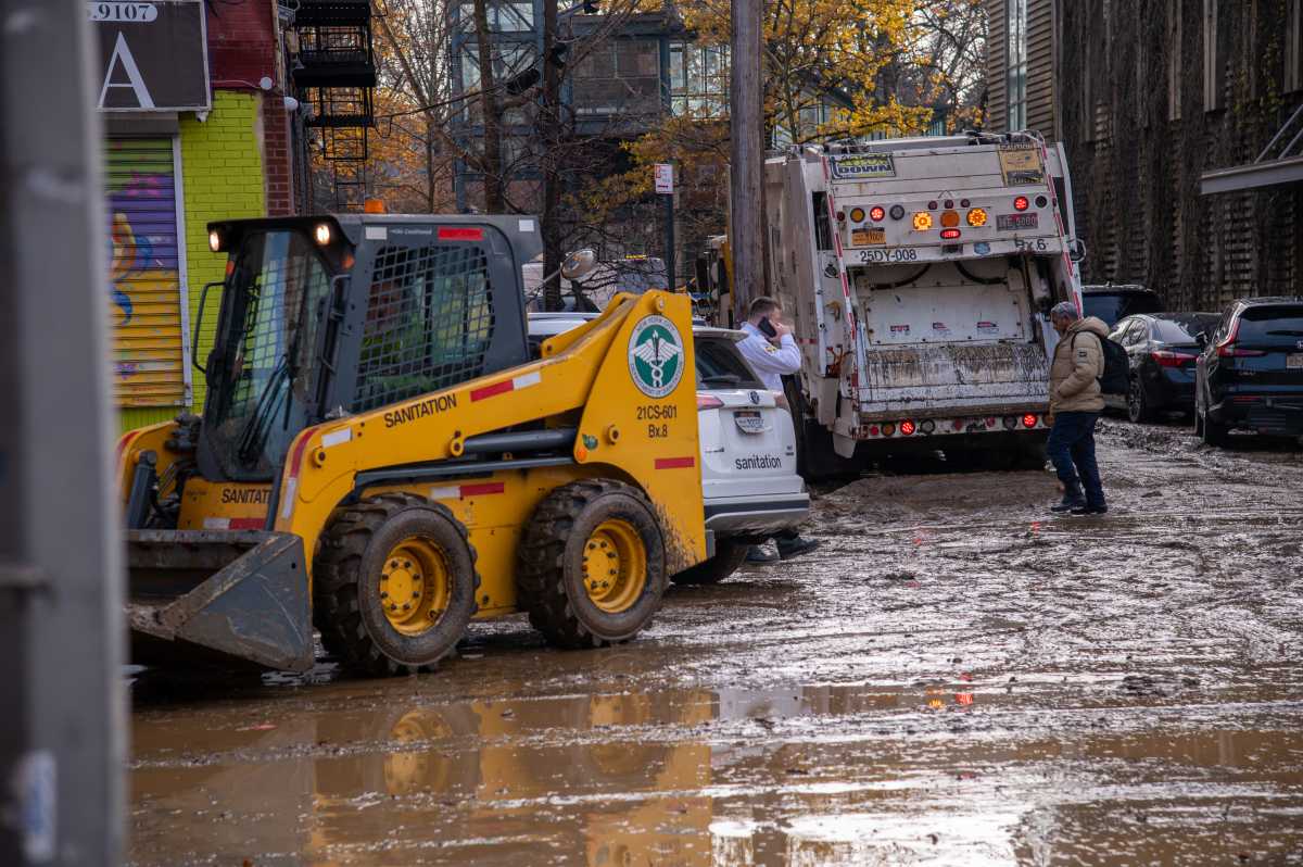 A water main rupture in Bedford Park left streets caked in mud and trash and displaced residents living in ground floor and basement apartments.