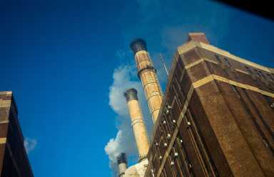 Smokestacks Send Condensation And Pollution Into The Air Of New York City.