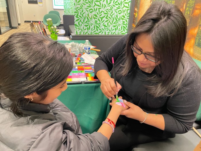 There were no bored kids waiting on their parents to finish banking on Friday. Instead young Bronxites could enjoy a piece of chocolate, catch a juggling show or get some artful designs painted on their hands.