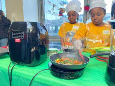 Students from the Throop elementary school sautéed chick peas with carrots and swiss chard for the first round of the "Battle of the Basket" cooking competition Thursday.