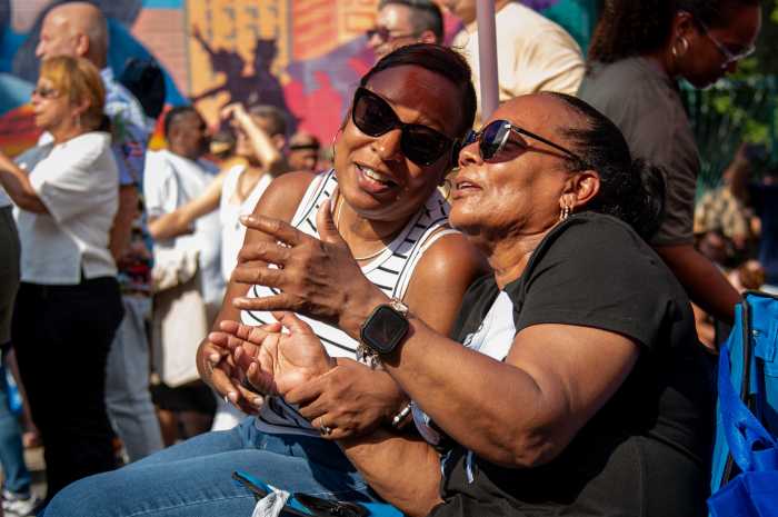 Olga De Aza and her daughter, who goes by the same name, sing in unison to a familiar song by Frankie Ruiz Jr. at the Longwood Festival over the weekend.
