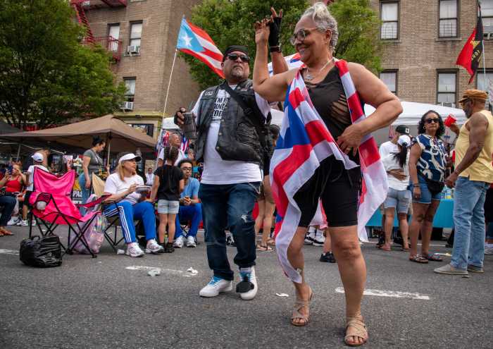 Longtime friends Edgar Cruz and Leila Ramirez were laughing and dancing in the street Saturday, celebrating their shared Puerto Rican roots at the 2025 Longwood Festival in the South Bronx.