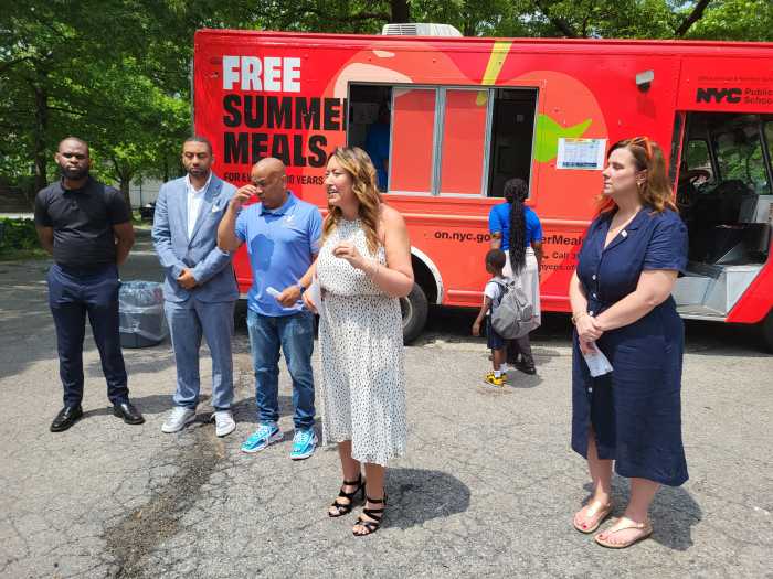 people at food truck giving out free summer meals to battle hunger