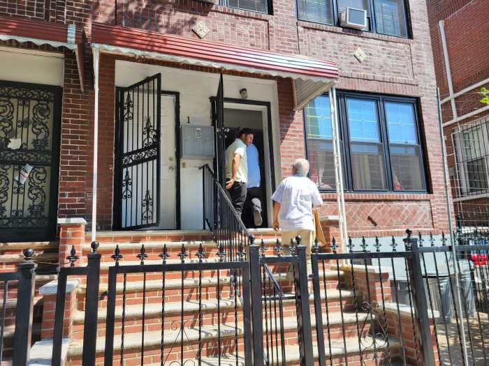 People walking into Bronx home of slain officer in Midtown mass shooting