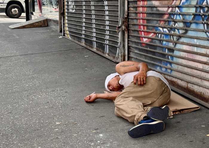 A man lays unconscious, but breathing, with a syringe in his hand on Melrose Ave.
