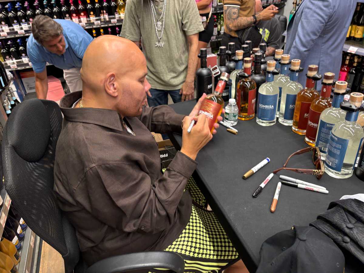 Bronx-born rapper and entrepreneur, Joseph Cartagena, also known as Fat Joe autographed bottles of Sonrisa rum at a Throggs Neck liquor store Tuesday. The hip hop legend partnered with the brand, which gives back to small business owners in Puerto Rico, where the rum is distilled.