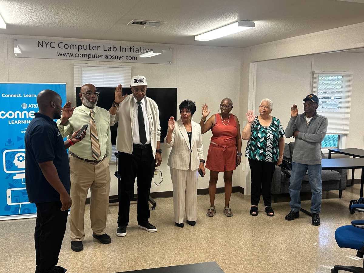 People standing in a circle and taking an oath of office to join PSA 8 Tenant Council