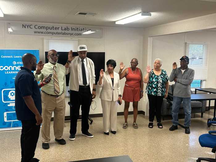 People standing in a circle and taking an oath of office to join PSA 8 Tenant Council
