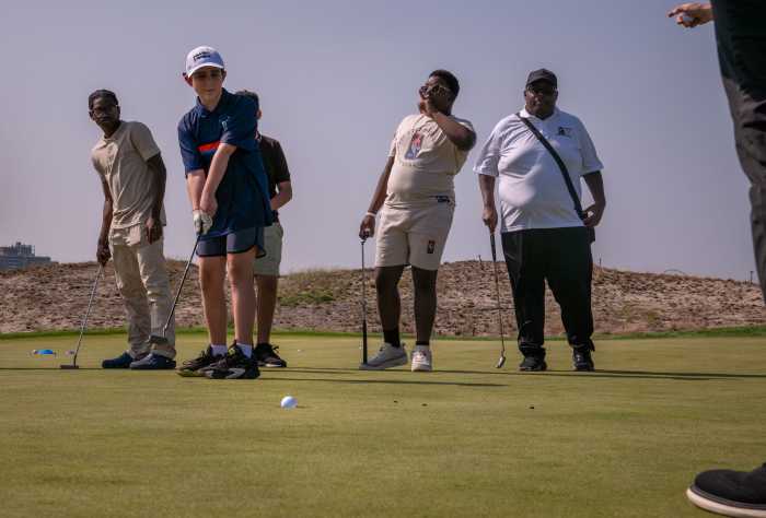 Dylan Garcia, 12, becomes the only junior golfer in his group to sink a putt in one shot during the competition. He told the Bronx Times that he made sure to pay attention to the slope of the course to anticipate where the shot would send his golf ball.