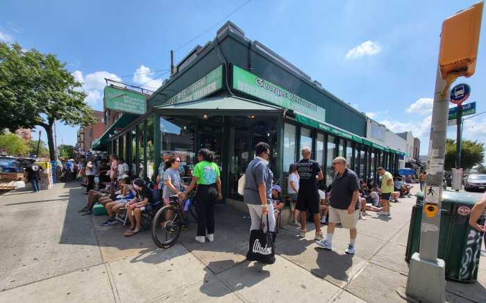 people lined up outside bank branch for Shakespeare in the Park tickets