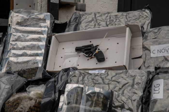 A joint task force seized an estimated ton of illegal cannabis products as well as a .22 caliber revolver , $20,000 in cash, some crystal meth and some illegal tobacco products. 
