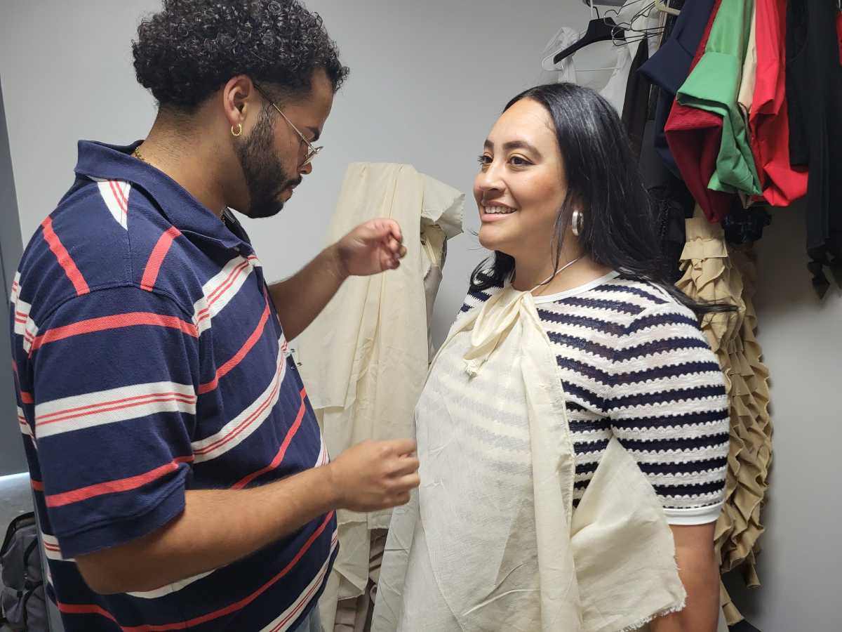 Bronx designer with woman on fitting a dress for a fashion show