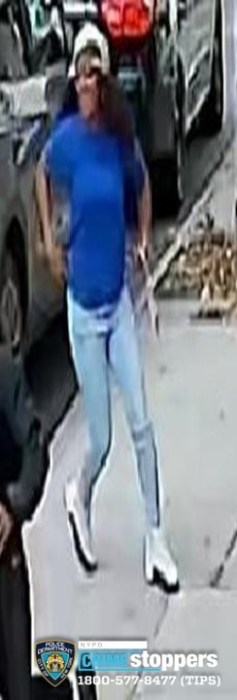 Individual #3 running from the scene of the car robbery. She was last seen wearing a blue shirt, blue pants, white and black shoes, and a light-colored baseball hat.