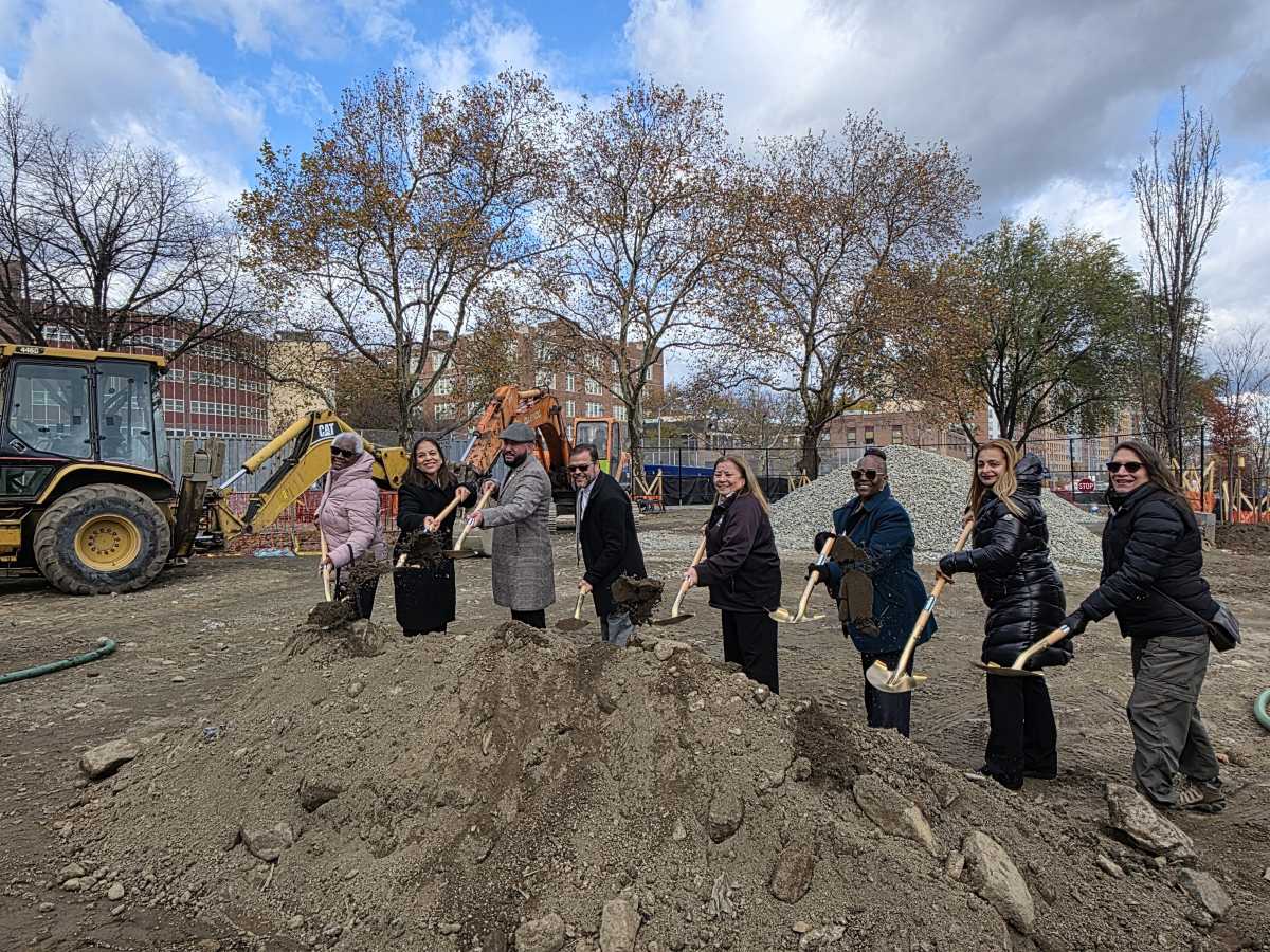 Parks Department commissioners, Community Board 3 leaders and elected officials lift dirt with gold shovels to officially break ground at Daniel Boone Playground in the Longwood neighborhood.