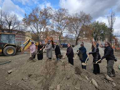 Parks Department commissioners, Community Board 3 leaders and elected officials lift dirt with gold shovels to officially break ground at Daniel Boone Playground in the Longwood neighborhood.