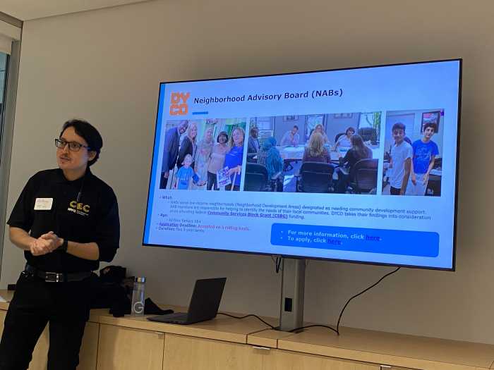 Anthony Carrión in front of a screen describing the benefit of joining a Neighborhood Advisory Board.