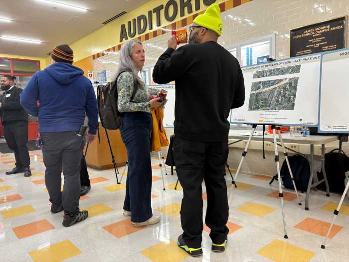 Anna Berlanga (center) and Edmundo Martinez (right) discussed the state's plans in front of one of the project's informational posters at a recent public hearing for the Cross Bronx Expressway Five Bridges Project.