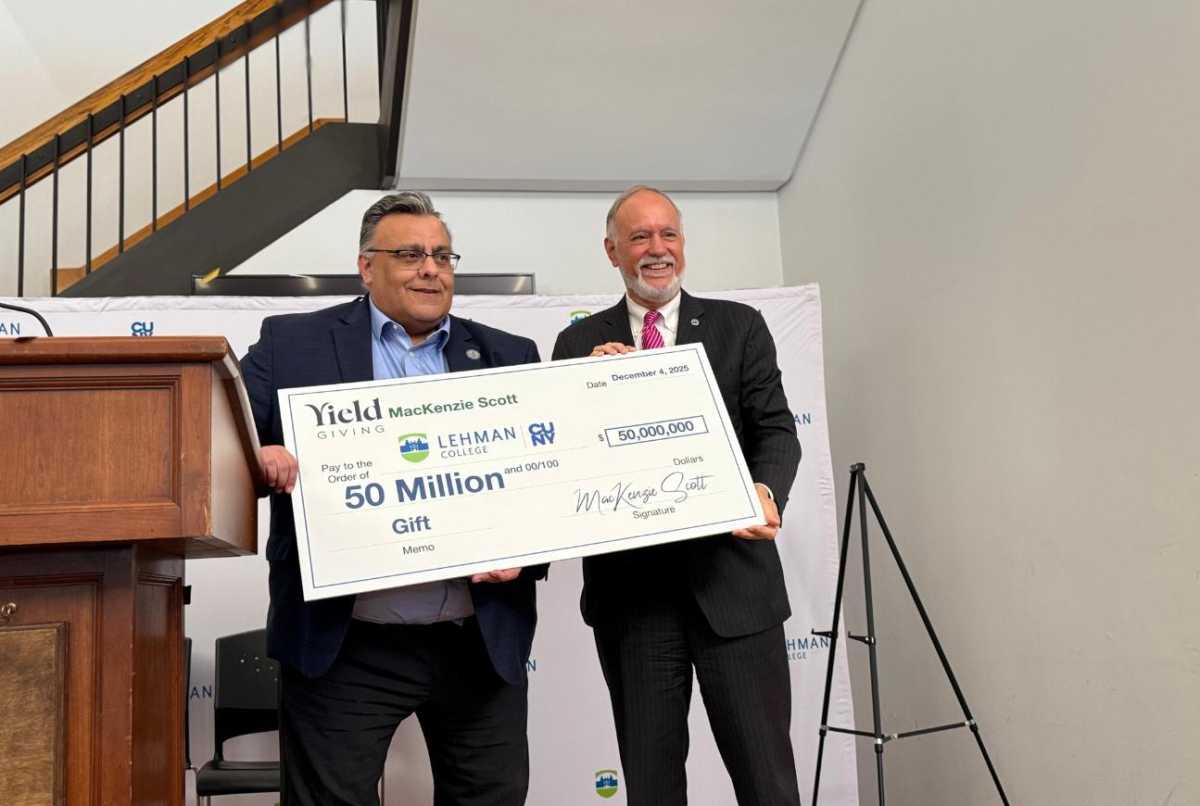 CUNY Chancellor, Félix Matos Rodríguez and Lehman College President Fernando Delgado hold up a check for $50 million dollars from philanthropist Mackenzie Scott, in what represents a "historic investment" in Bronx students.