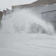 man plows snow along Bruckner Blvd near East 138th Street
