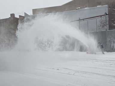 man plows snow along Bruckner Blvd near East 138th Street