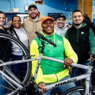 TD Bank volunteers and Bike New York instructors pose in front of a newly-built bike.