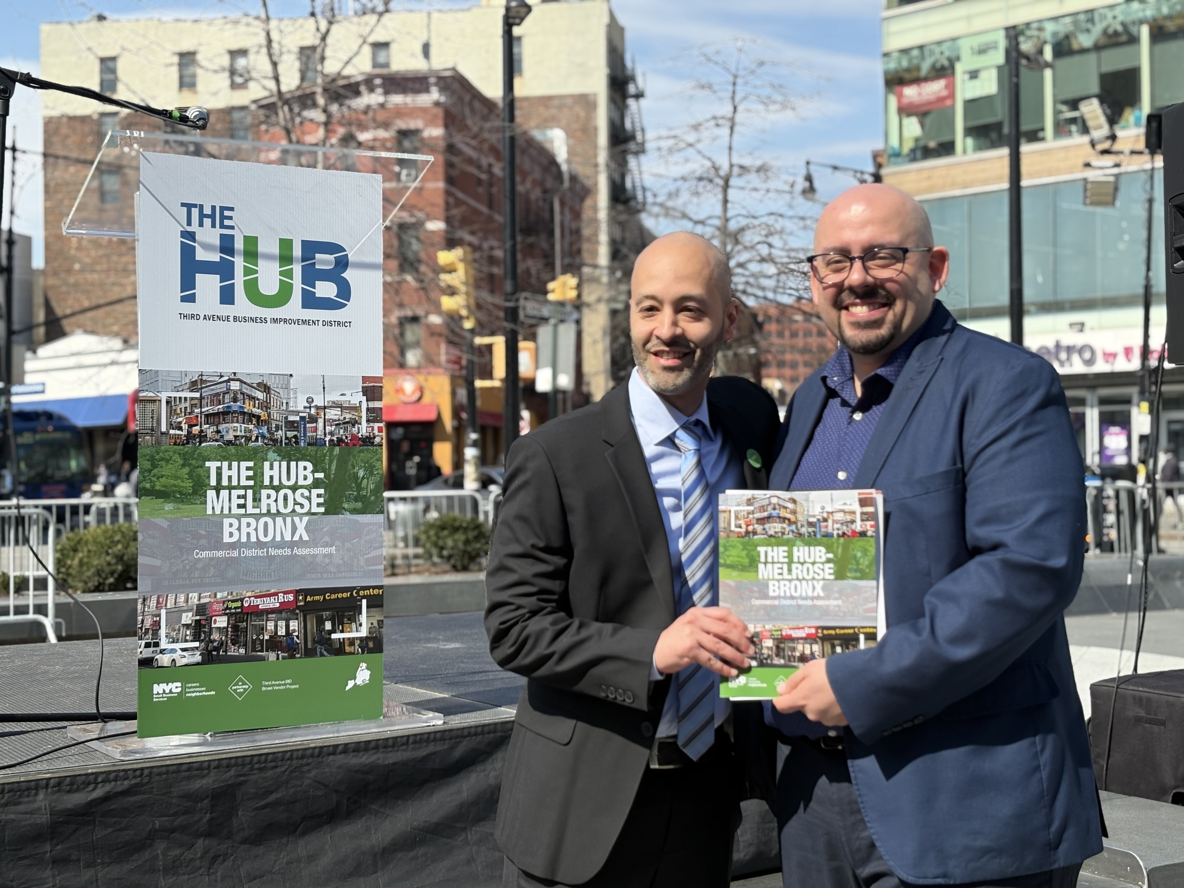 Third Avenue BID executive director Pedro Suarez and Department of Small Businesses commissioner Kenny Minaya in Roberto Clemente Plaza with the results of the Commercial District Needs Assessment.