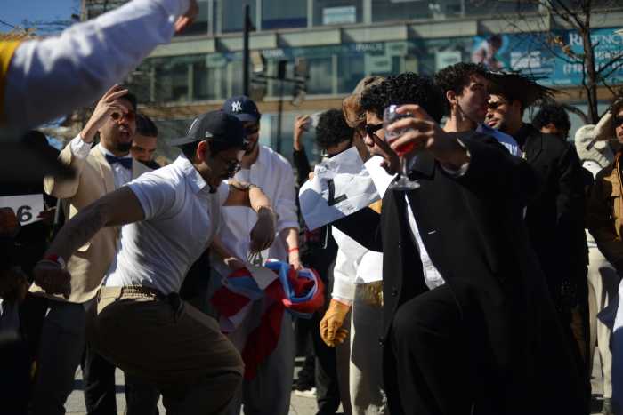 Bad Bunny lookalikes dance to dembow music to prepare for their stage performance.