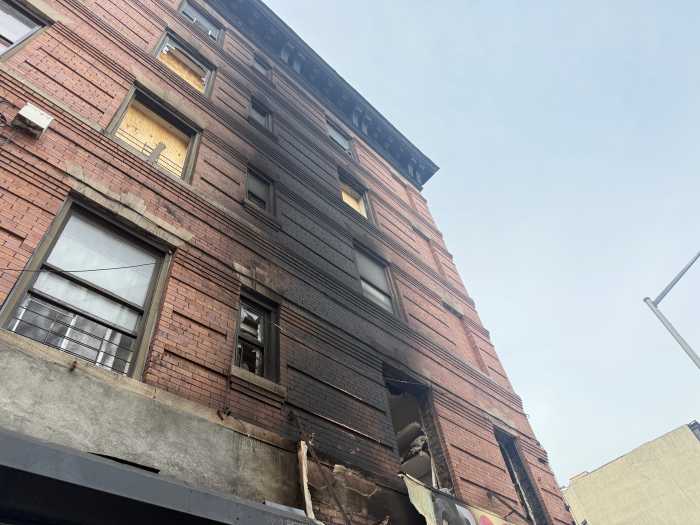 The fire reached four stories of residential apartments above the grocery store.