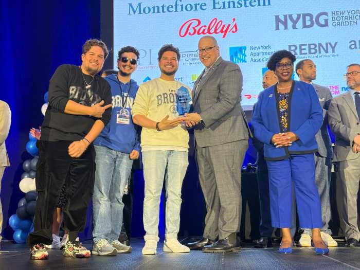State Sen. Gustavo Rivera presenting the Change Maker Award to the Bronx Beer Hall, alongside Bronx District Attorney Darcel Clark.