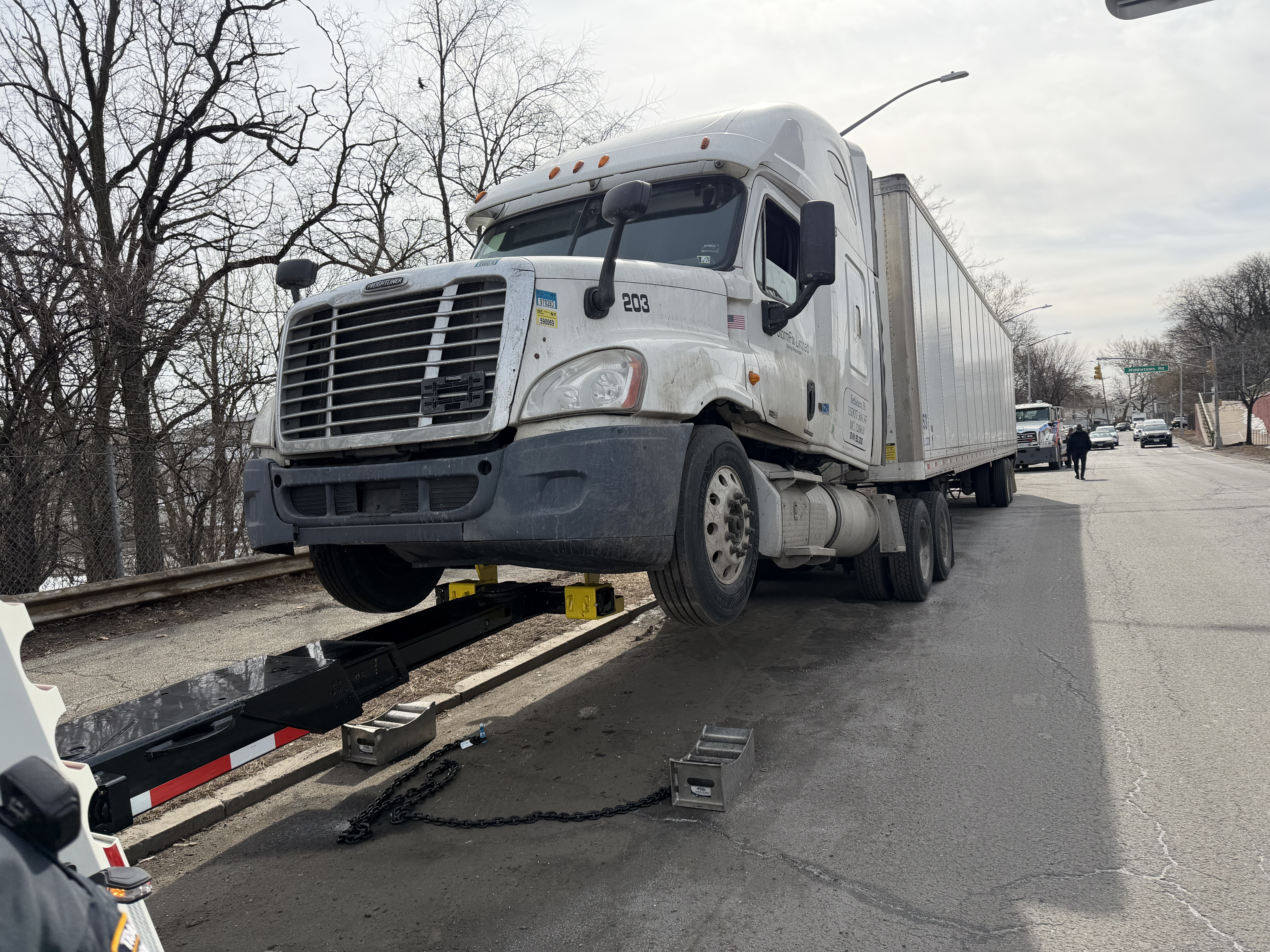 A large truck is towed from Bruckner Blvd. near Pelham Bay Park