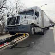 A large truck is towed from Bruckner Blvd. near Pelham Bay Park