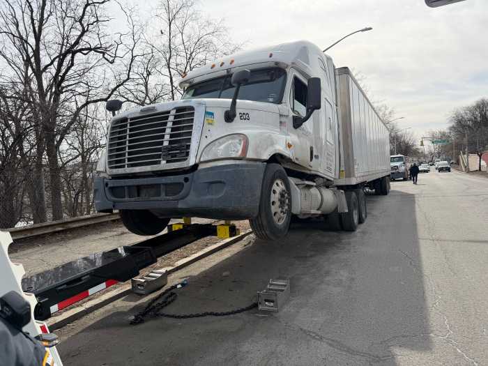 A large truck is towed from Bruckner Blvd. near Pelham Bay Park