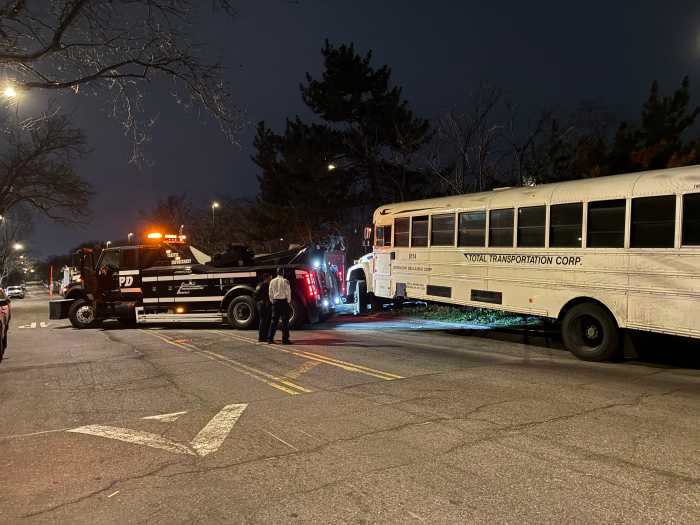 A large bus is removed from the Throgs Neck Expressway service road.