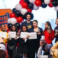 Colin Kaepernick, founder of LUMI AI, poses with ten ninth graders who created graphic novels using the app at DREAM Charter School in Mott Haven.