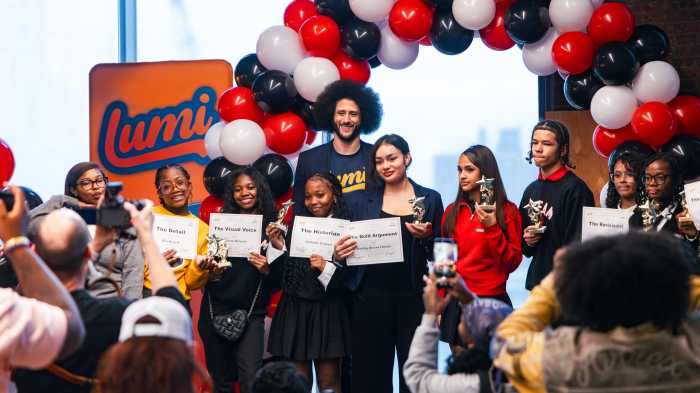 Colin Kaepernick, founder of LUMI AI, poses with ten ninth graders who created graphic novels using the app at DREAM Charter School in Mott Haven.