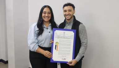 Bronx Community Board 10 District Manager Matt Cruz receives proclamations from Council Member Amanda Farías