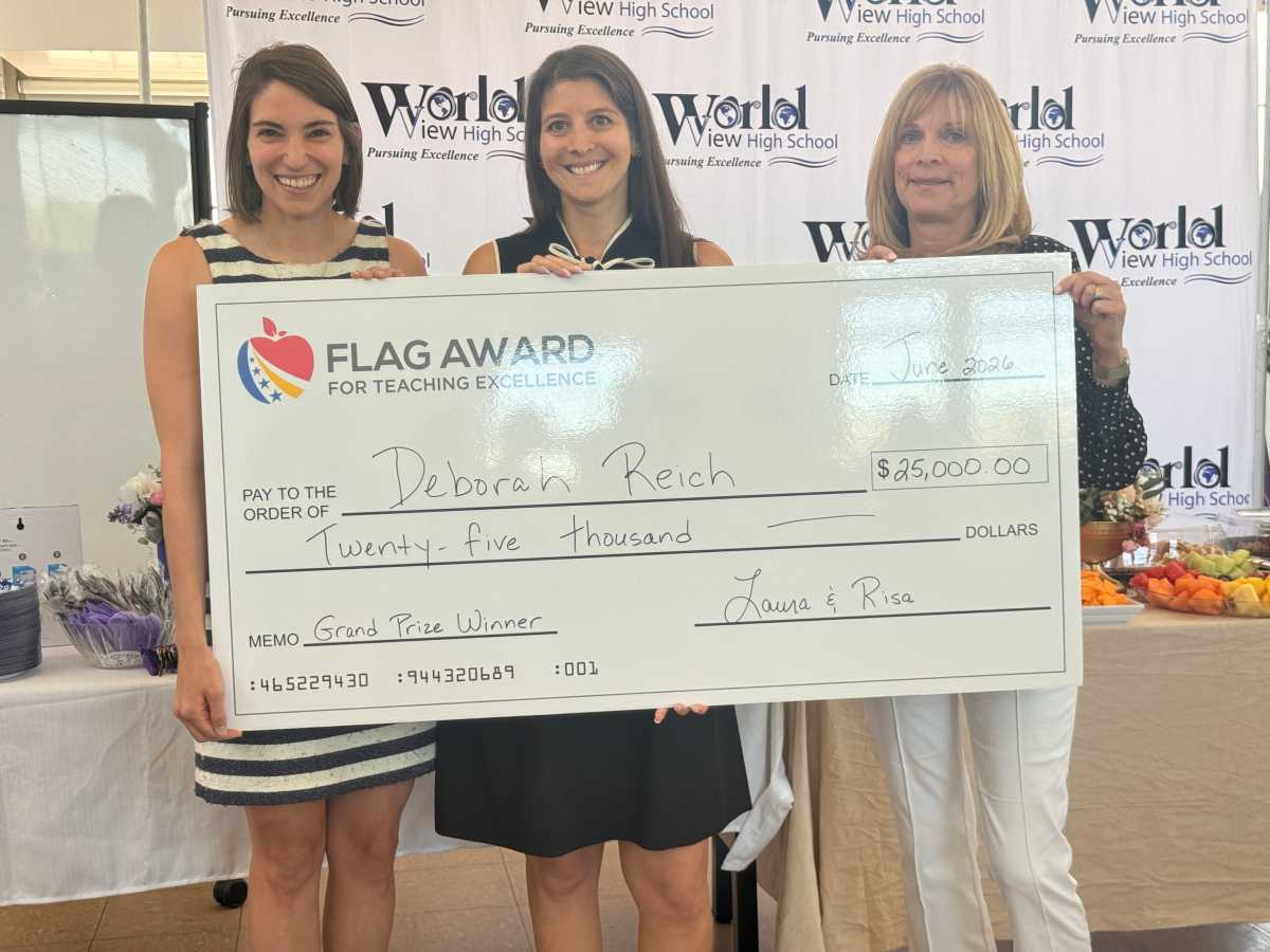 Deborah Reich (center) holds her $25,000 ceremonial check for her work in World View High School with co-presidents Risa Daniels (left) and Laura Twersky (right).