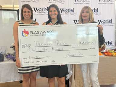 Deborah Reich (center) holds her $25,000 ceremonial check for her work in World View High School with co-presidents Risa Daniels (left) and Laura Twersky (right).