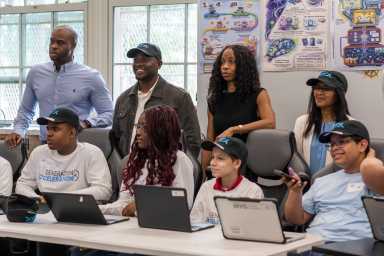 District 12 Council Member Kevin Riley with students at Leaders of Tomorrow middle school in Olinville.