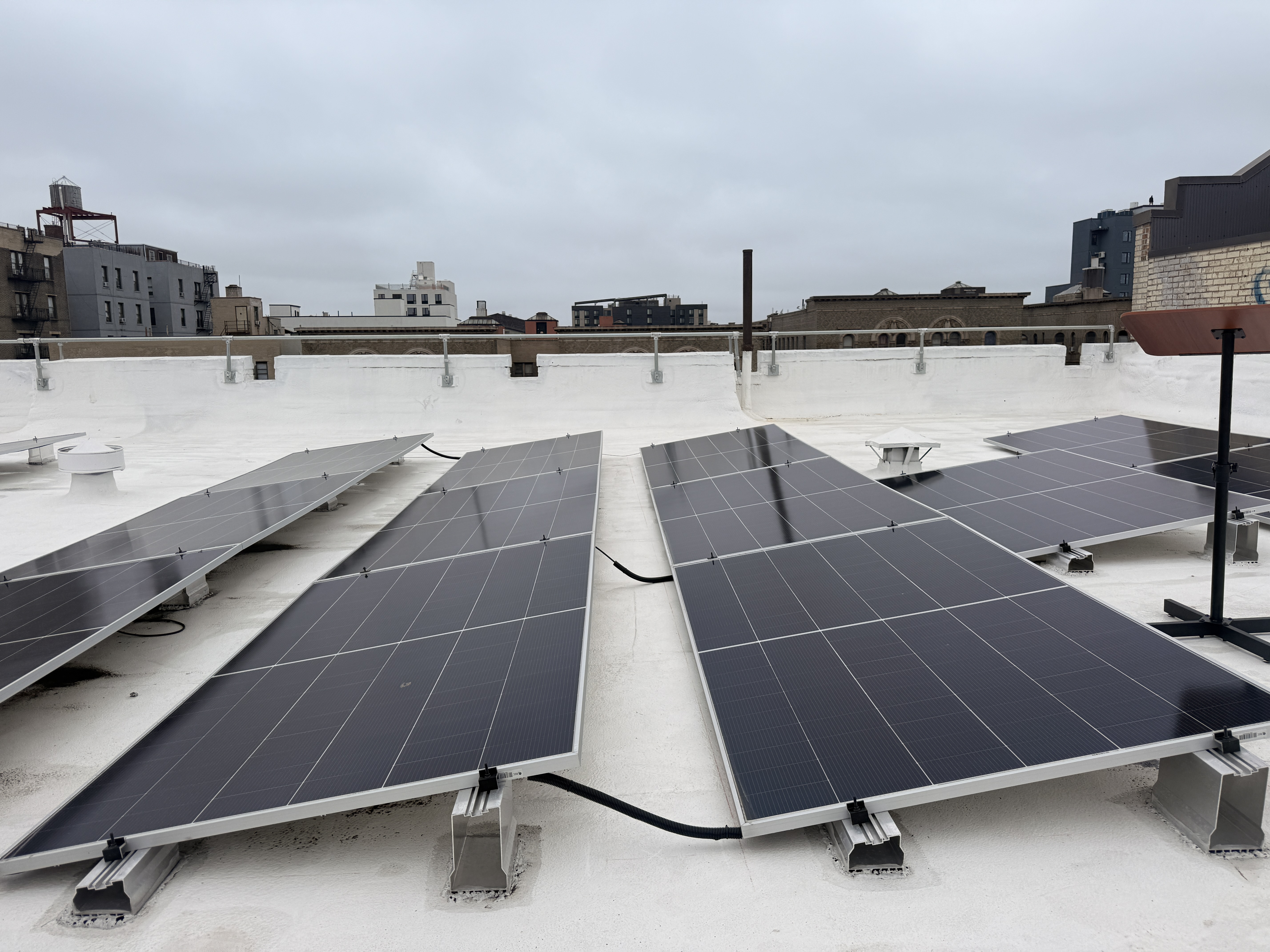 Solar panels atop 2676 Grand Concourse, one of the buildings participating in Fieldston Power's community distributed solar network.