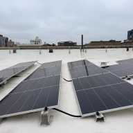 Solar panels atop 2676 Grand Concourse, one of the buildings participating in Fieldston Power's community distributed solar network.