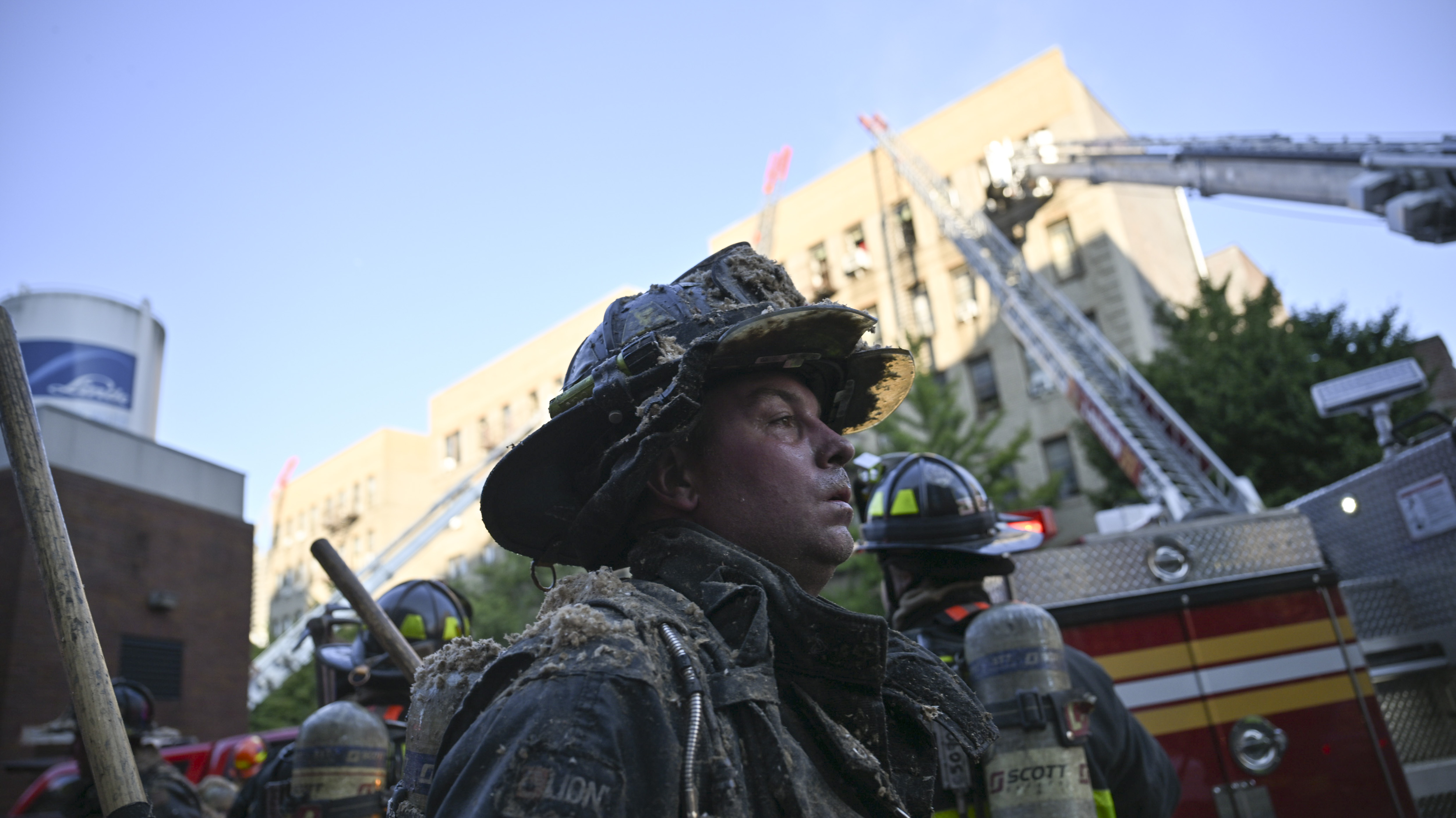 Firefighters at the scene of a four alarm fire at 3422 Dekalb Avenue. The fire would take two hours to bring under control.