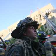 Firefighters at the scene of a four alarm fire at 3422 Dekalb Avenue. The fire would take two hours to bring under control.