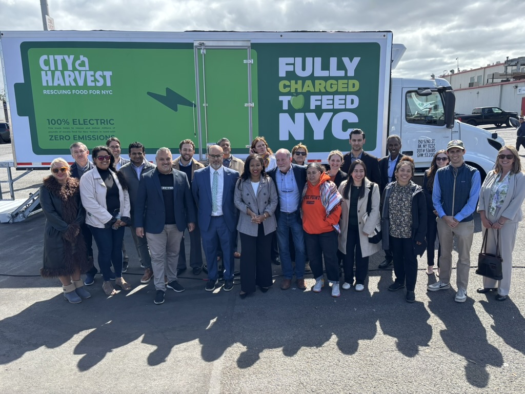Hunts Point community stakeholders from the Bronx is Breathing project celebrate the launch of three electric trucks that will be supporting City Harvest deliveries.