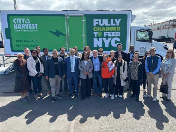 Hunts Point community stakeholders from the Bronx is Breathing project celebrate the launch of three electric trucks that will be supporting City Harvest deliveries.