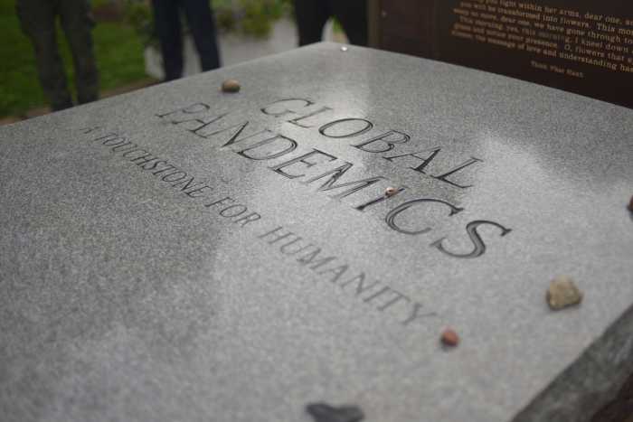 A headstone honoring the victims of Covid-19 buried on Hart Island.