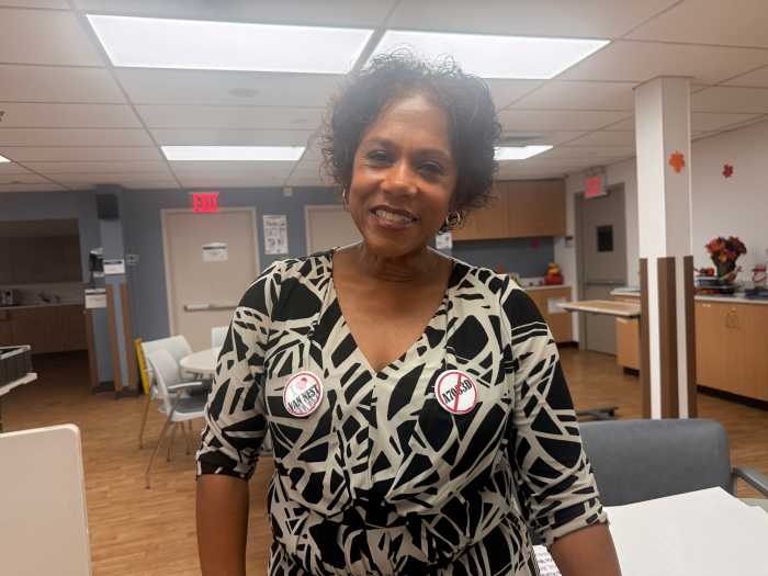 Sharlene Jackson Mendez, vice president of the Van Nest Neighborhood Alliance, dons a pin that says "I Love Van Nest" and another with an X through the Assembly bill number.